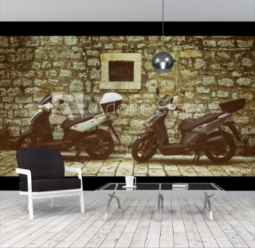 Picture of Two Mopeds in front of the Wall
